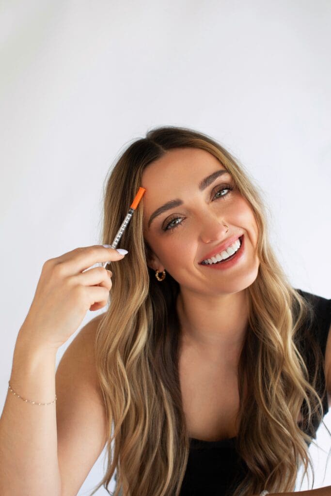 A woman with natural facial expressions smiling softly, representing subtle, anatomy-driven Botox results without the frozen look.